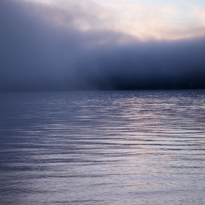 Fog over water at sunrise. Sinclair Inlet, Bremerton, Washington.